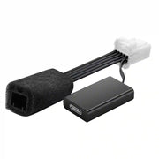 Computer hardware components including a black connector and a rectangular black device on a white background