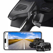 Car dashboard camera mounted on a car's windshield with a smartphone displaying a road scene.